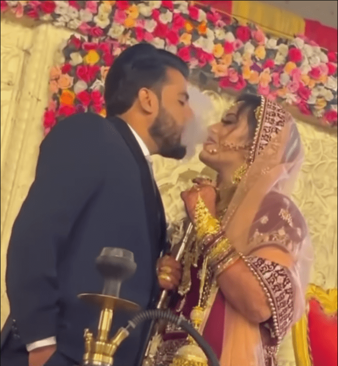 the-bride-abd-groom-were-smoking-hookah-on-the-stage-at-their-wedding