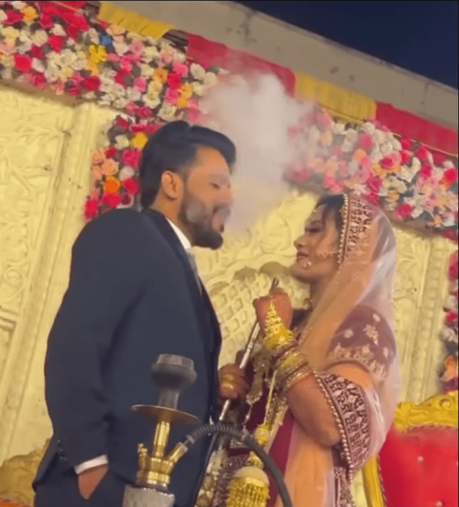 the-bride-abd-groom-were-smoking-hookah-on-the-stage-at-their-wedding